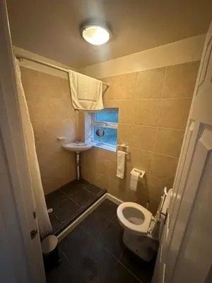 a small bathroom with a toilet and a sink at 1 bed annex with extra sofa bed ideal for families and business guests in Littleport