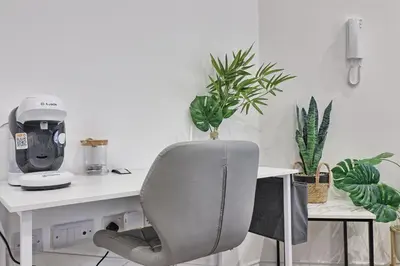 a white desk with a chair and some plants at Chelmsford City Central Ground Floor Apartment Next To Town Centre in Chelmsford
