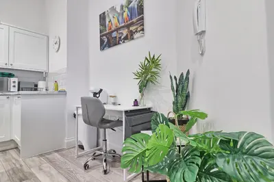 an office with a desk and a chair and plants at Chelmsford City Central Ground Floor Apartment Next To Town Centre in Chelmsford