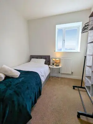 a bedroom with a bed and a window at 3-Bed, Sleeps 6, 3 Bath, Parking, WiFi in Watton