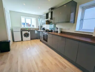 a large kitchen with a washer and dryer at 3-Bed, Sleeps 6, 3 Bath, Parking, WiFi in Watton