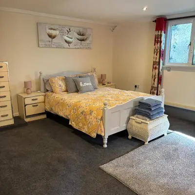 a bedroom with a bed and a dresser at 2 Bed Barn - Sleeps 4 - Pets - Parking - Wifi in Downham Market