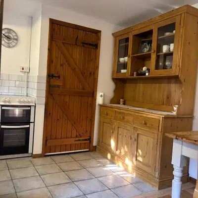 a kitchen with a wooden door and a stove at 2 Bed Barn - Sleeps 4 - Pets - Parking - Wifi in Downham Market
