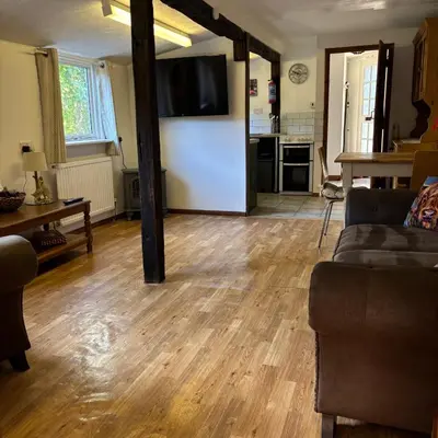 a living room with a couch and a kitchen at 2 Bed Barn - Sleeps 4 - Pets - Parking - Wifi in Downham Market