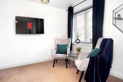 a living room with two chairs and a table at Yew Tree Close Mildenhall Bury St Edmunds in Mildenhall