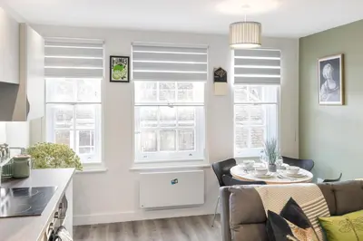 a kitchen and dining room with windows and a table at Ipswich Town center Gem Sleep 5 in Ipswich