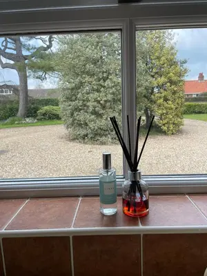 two bottles sitting on a window sill with a window view at The Grange in Attleborough