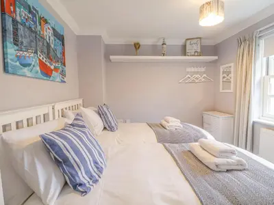 a bedroom with a bed with two towels on it at 23 Church Farm Lane in Halesworth