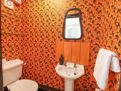 a bathroom with a toilet and a sink at 23 Church Farm Lane in Halesworth