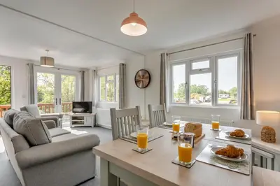 a living room with a table with orange juice on it at 2 Bed in Welney oc-k29369 in Welney