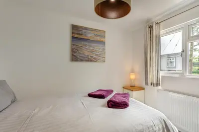 a bedroom with a bed with two purple pillows on it at 2 Bed in Welney oc-k29369 in Welney