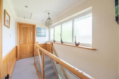 a staircase in a house with windows at 5 Toller Close, Orford in Orford
