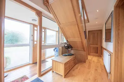 a home office with a desk and windows at 5 Toller Close, Orford in Orford