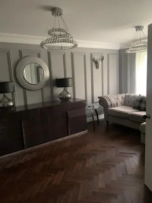 a living room with a couch and a mirror at Boutique bungalow in Haverhill