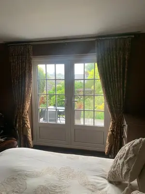a bedroom with a large window and a bed at Boutique bungalow in Haverhill