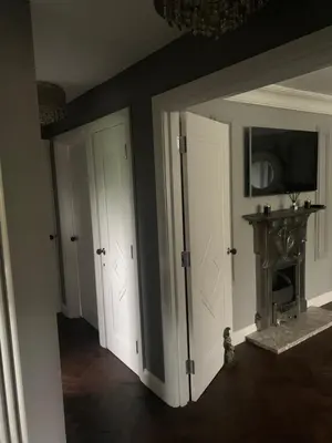 two doors in a room with a fireplace at Boutique bungalow in Haverhill