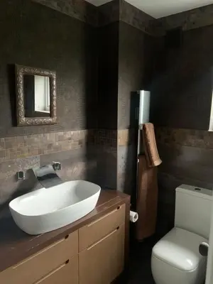 a bathroom with a white sink and a toilet at Boutique bungalow in Haverhill