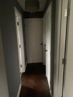 an empty hallway with a chandelier in a room at Boutique bungalow in Haverhill