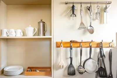 a kitchen with utensils hanging on a wall at Skylark - Sweffling Hall in Rendham