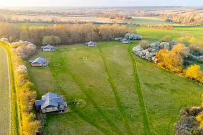 an aerial view of a large green field with houses at Skylark - Sweffling Hall in Rendham
