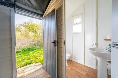 a bathroom with a toilet and a sink at Skylark - Sweffling Hall in Rendham