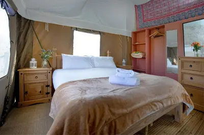 a bedroom with a large bed with towels on it at Swallow - Sweffling Hall in Rendham