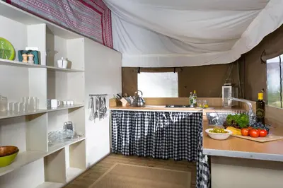 a kitchen with a sink and a counter with fruits and vegetables at Swallow - Sweffling Hall in Rendham