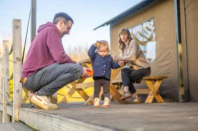 a man and a woman and a child on a dock at Sweffling at Lantern and Larks in Rendham