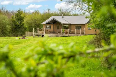 a small house with a porch in a field at Sweffling at Lantern and Larks in Rendham