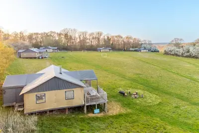 an aerial view of a house in a field at Swift - Sweffling Hall in Rendham