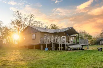 a large house with a porch and a deck at Swift - Sweffling Hall in Rendham
