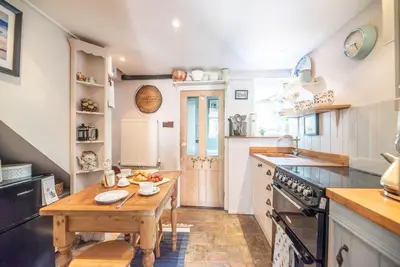 a kitchen with a wooden table and a wooden counter top at 2 Fox Cottage, Darsham in Darsham