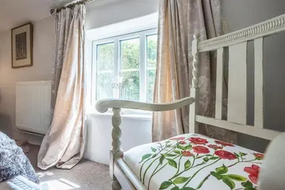 a bedroom with a bed and a window at 2 Fox Cottage, Darsham in Darsham