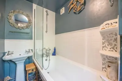 a bathroom with a tub and a sink at 2 Fox Cottage, Darsham in Darsham