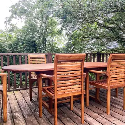 a wooden table and chairs on a deck at Captivating 1-Bed Cabin in Newmarket in Newmarket