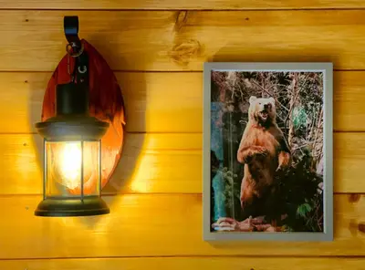 a picture of a bear on a wall next to a lamp at Beautiful 1-Bed Cabin in Newmarket in Newmarket