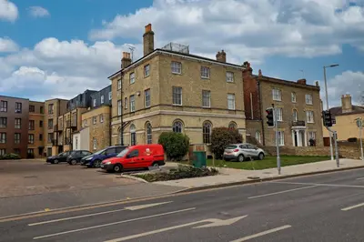 a street with cars parked in front of a building at Chelmsford City Centre Modern Duplex With Parking, Wi-Fi & Netflix in Chelmsford