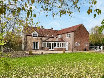 an image of a brick house with a yard at Sandy Toes Cottage in Beechamwell