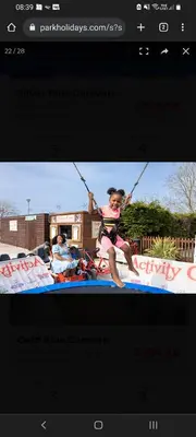 a woman on a surfboard being pulled by two poles at SKYLA VISTA Deluxe in Clacton-on-Sea