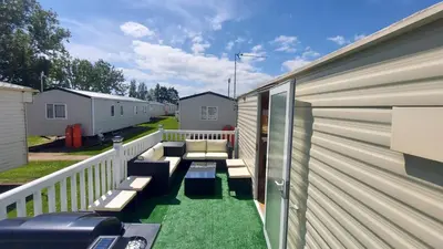 a balcony with a couch and chairs on a house at SKYLA VISTA Deluxe in Clacton-on-Sea