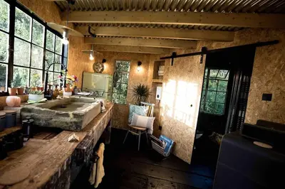 a large bathroom with a large tub and a table at Unique glamping experience near Ely & Cambridge in Ely