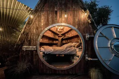 a large wooden house with a bed in it at Unique glamping experience near Ely & Cambridge in Ely