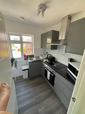 a kitchen with stainless steel appliances and gray cabinets at Cosy rooms in Cambridge in Cambridge