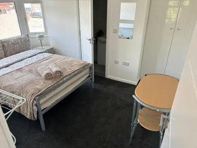 a bedroom with a bed and a table and a chair at Cosy rooms in Cambridge in Cambridge