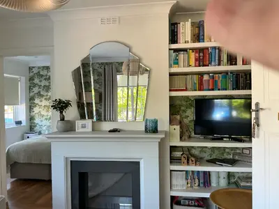 a living room with a fireplace and a tv at Frinton45 in Frinton-on-Sea