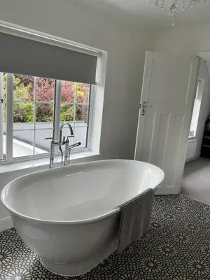 a white bath tub in a bathroom with a window at Frinton45 in Frinton-on-Sea
