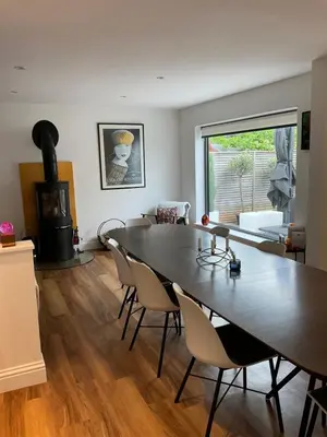 a dining room with a table and chairs and a fireplace at Frinton45 in Frinton-on-Sea