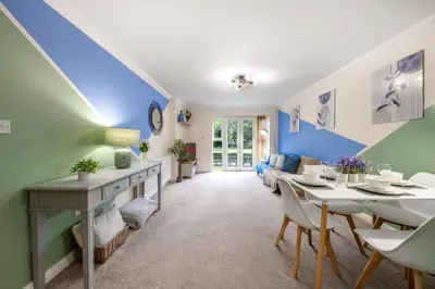 a living room with a blue and green wall at STN - Bishops's Stortford - Free Gated Parking - Two Bed Apartment - Perfect location for Stansted Airport in Bishops Stortford