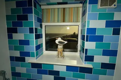 a bathroom with a window with a bird in it at The Brudenell in Aldeburgh