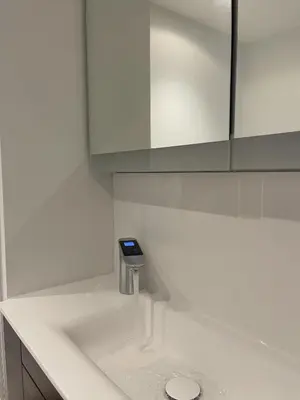 a white bathroom with a soap dispenser on a counter at The Melodies with Free Parking , Harlow in Harlow